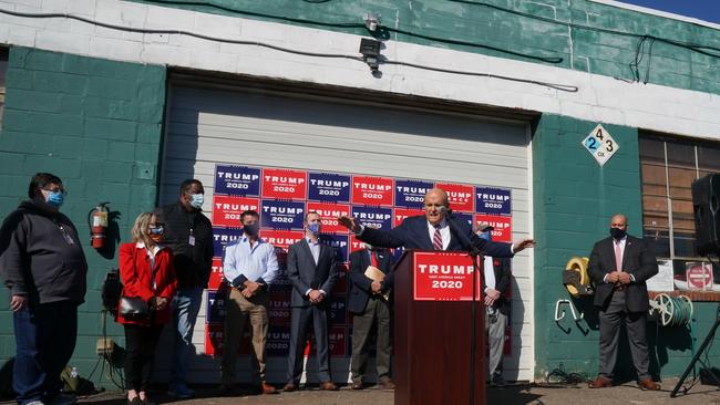 Rudy Giuliani speaks at a news conference in the parking lot of a landscaping company in Philadelphia. It was first billed as a major press event at Philadelphia's Four Seasons hotel for a briefing by Donald Trump's lawyers but the site was a suburban garden centre next to a sex shop. Picture: AFP