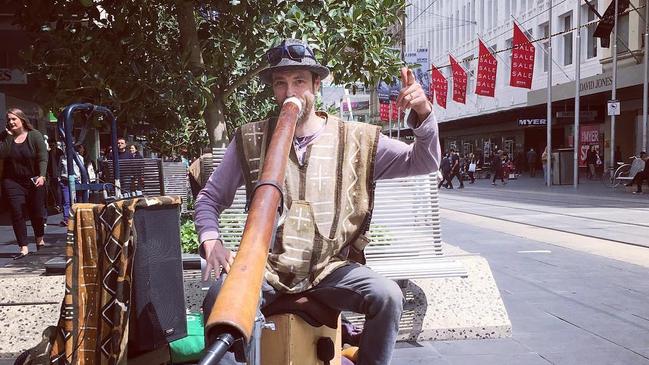 Busker Daniel “Animus” Richardson playing the didgeridoo in Bourke Street Mall.