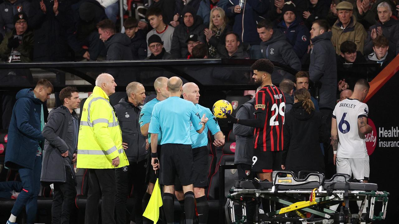 Referee Simon Hooper is handed the match ball by Philip Billing of AFC Bournemouth as players of Luton Town and AFC Bournemouth leave the field. Photo by Warren Little/Getty Images.