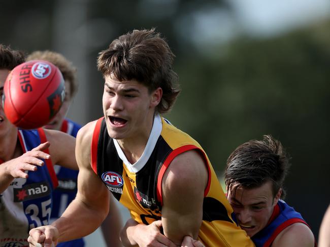 Will Bravo of the Stingrays handballs during the NAB league match between Dandenong Stingrays and the Gippsland Power played at Putney Street Dandenong on Saturday 27th July, 2019