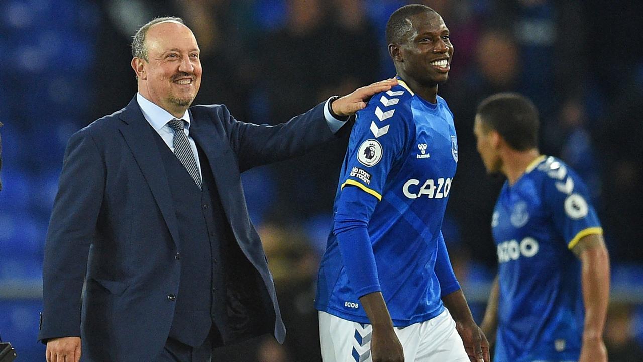 Everton's Spanish manager Rafael Benitez congratulates Everton's French midfielder Abdoulaye Doucoure on the pitch .