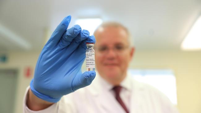 Jab this: Scott Morrison gets to grips with a AstraZeneca vaccine during a trip to the Therapeutic Goods Administration (TGA). Picture: Adam Taylor