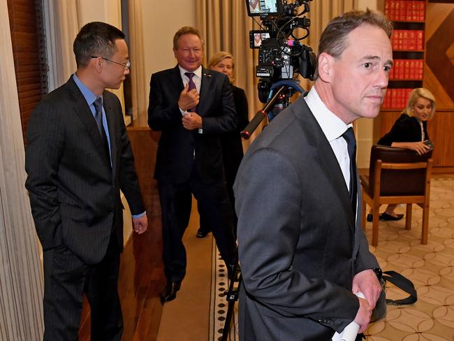 Health minister Greg Hunt (foreground) leaves a press conference at the Commonwealth Parliamentary Offices in Melbourne yesterday as Long Zhou (left) and Andrew Forrest (centre) look on. Picture: AAP