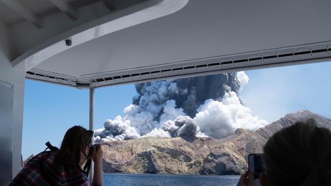 Smiling tourists turned emergency responders after the eruption. Picture: Michael Schade via AP