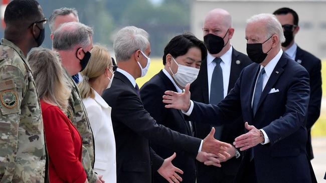 Japan's Foreign Minister Yoshimasa Hayashi, centre, and US Ambassador to Japan Rahm Emanuel, centre left, greet US President Joe Biden, at Yokota Air Base. Biden said “there is a sense among the democracies in the Pacific that there’s a need to co-operate much more closely.” Picture: AFP