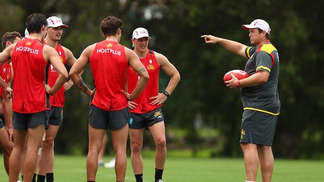 Senior coach Stuart Dew talks to players during a Gold Coast Suns training session at Metricon Stadium. Photo: Chris Hyde/Getty Images