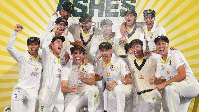 TOPSHOT - Australia's players celebrates with the trophy after defeating England on the third day of the fifth Ashes cricket Test match in Hobart on January 16, 2022. (Photo by William WEST / AFP) /