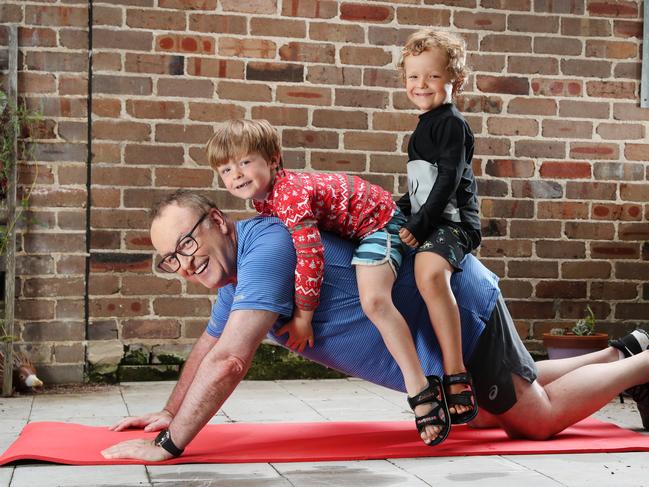 Chris Smith, with sons Gus and Harry, has vowed to shed weight after stacking the kilos on with late-snacking. Picture: Richard Dobson