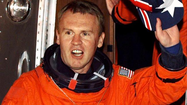 Adelaide astronaut Dr Andy Thomas seen waving an Australian flag baseball cap before he spent several months on-board the Russian space station Mir in 1998. Picture: AFP