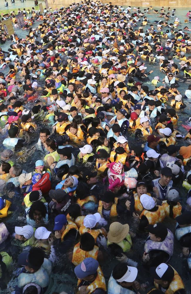 People crowd in the Caribbean Bay swimming pool trying to escape the heat in Yongin, South Korea. Picture: Ahn Young-joon/AP