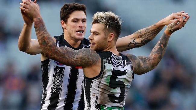 Jack Crisp celebrates a goal with Jamie Elliott.