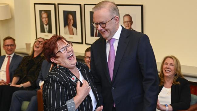 Braddon MP Anne Urquhart signs the Caucus membership book with Prime Minister Anthony Albanese at the Labor Party Caucus at Parliament House in Canberra. Picture: NewsWire / Martin Ollman