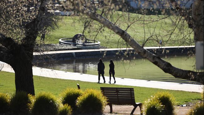 People walking at Lake Burley Griffin in Canberra during their allotted two hour exercise period. Picture: NCA NewsWire / Gary Ramage