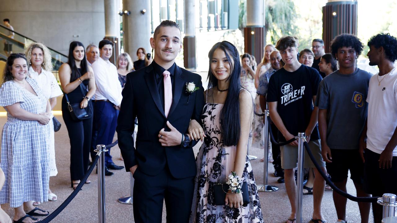 Melody Neal arrives at the Peace Lutheran College formal evening at the Cairns Convention Centre with her date Hunter Smith. Ms Neal was the victim of a stabbing at the school on May 16, which damaged her liver and severed nerves in her spine. Picture: Brendan Radke