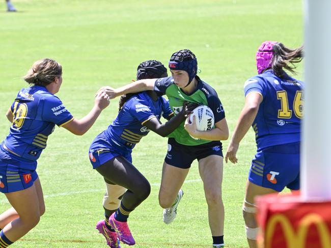 Maddison Higgins is tackled by Evelyn Kuwendu. Picture: Martin Ollman