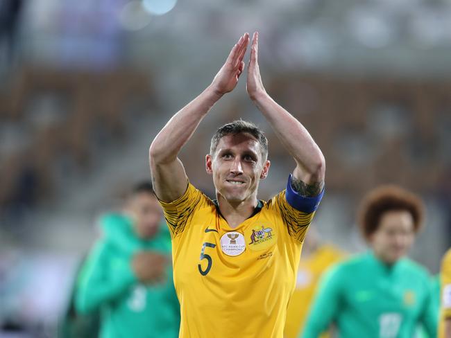 Mark Milligan celebrates as the Australians sent Uzbekistan out of the tournament.