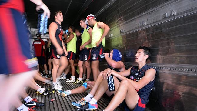 Melbourne footballers cool off in the refrigerated trailer.