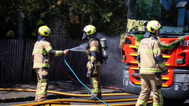 Firefighters wearing breathing apparatus freed a man from the burning home. Picture: Mark Stewart