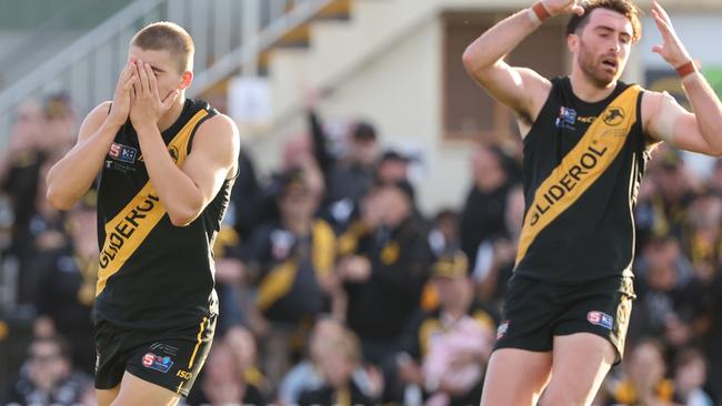 Glenelg’s Hugh Stagg (left) laments his late missed shot at goal against Port Adelaide that would have put the Tigers in front while teammate Liam McBean shows his disappointment at the missed opportunity. Picture: SANFL Image/David Mariuz.