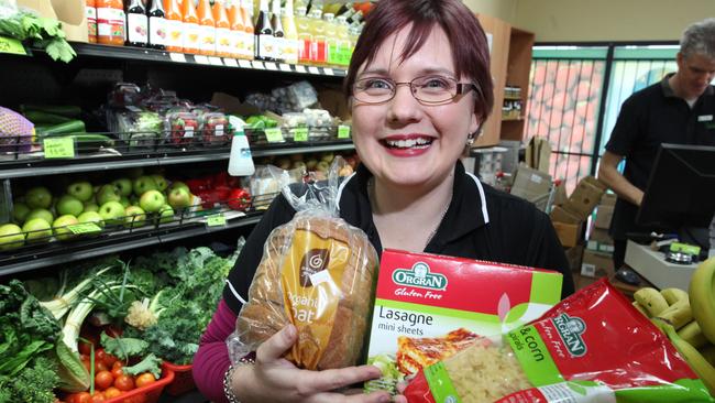 Kat Ord poses with gluten-free products at the Flannerys Chermside store. Photographer: Liam Kidston.