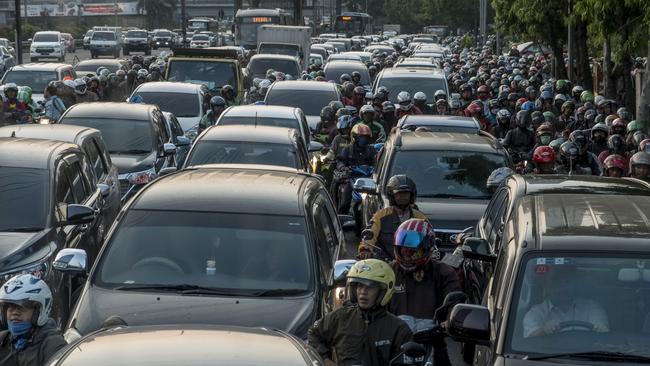 Commuters wait in a traffic jam during afternoon rush hour in Jakarta.