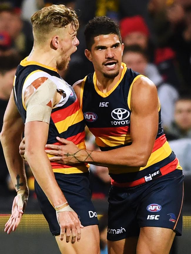 Crows Hugh Greenwood and Curtly Hampton celebrate a goal against the Eagles. Pictures: AAP Image/Mark Brake