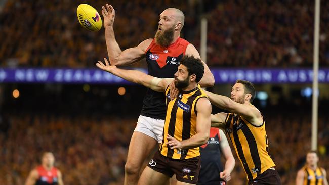 Max Gawn jumps over David Mirra and James Frawley.