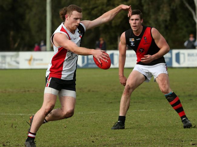 Lachlan Stenning of Bonbeach kicks forward against Frankston Bombers in June. Picture: Hamish Blair