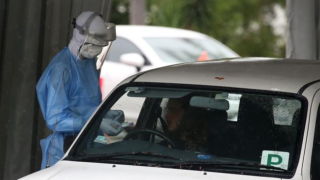 A worker tests a local resident at a COVID drive through testing clinic in Brisbane. (Photo by Jono Searle/Getty Images)