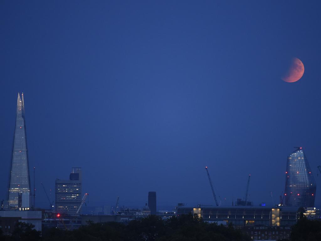 LONDON, ENGLAND - JULY 16: A partial lunar eclipse appears over the London skyline on July 16, 2019 in London, England. Today marked the 50th anniversary of the launch of Apollo 11, the US spaceflight that first landed humans on the moon. (Photo by Peter Summers/Getty Images)