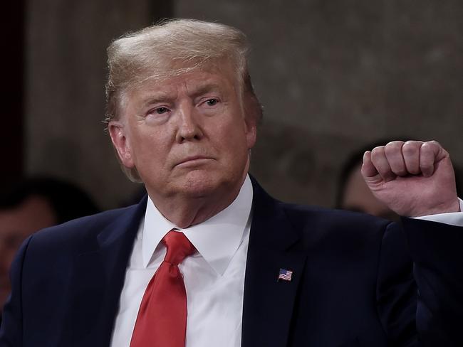 President Donald Trump pumps his fist as he delivers the State of the Union address in the chamber of the US House of Representatives at the US Capitol Building on February 4, 2020 in Washington, DC. (Photo by Olivier DOULIERY / AFP)