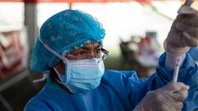 A health worker prepares to inoculate a child with a dose of the Pfizer-BioNTech vaccine. Picture: AFP.