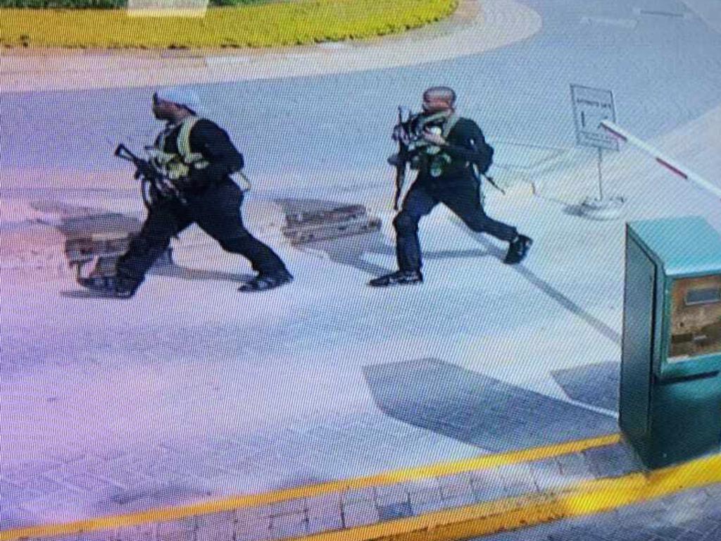 In this grab taken from security camera footage, heavily armed attackers walk in the compound of the hotel. Picture: AP