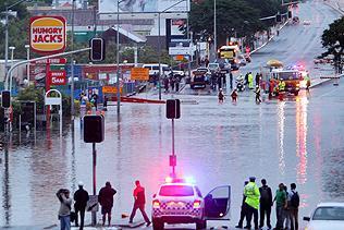 NO through road ... emergency crews direct motorists at a flooded Bowen Bridge Rd, next to the Royal Brisbane Hospital in Brisbane on May 20, 2009. Picture: Adam Smith