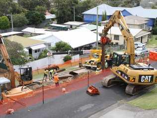 An excavator rams steel sheet piling into the site of the Yamba St landslip. Picture: Rodney Stevens