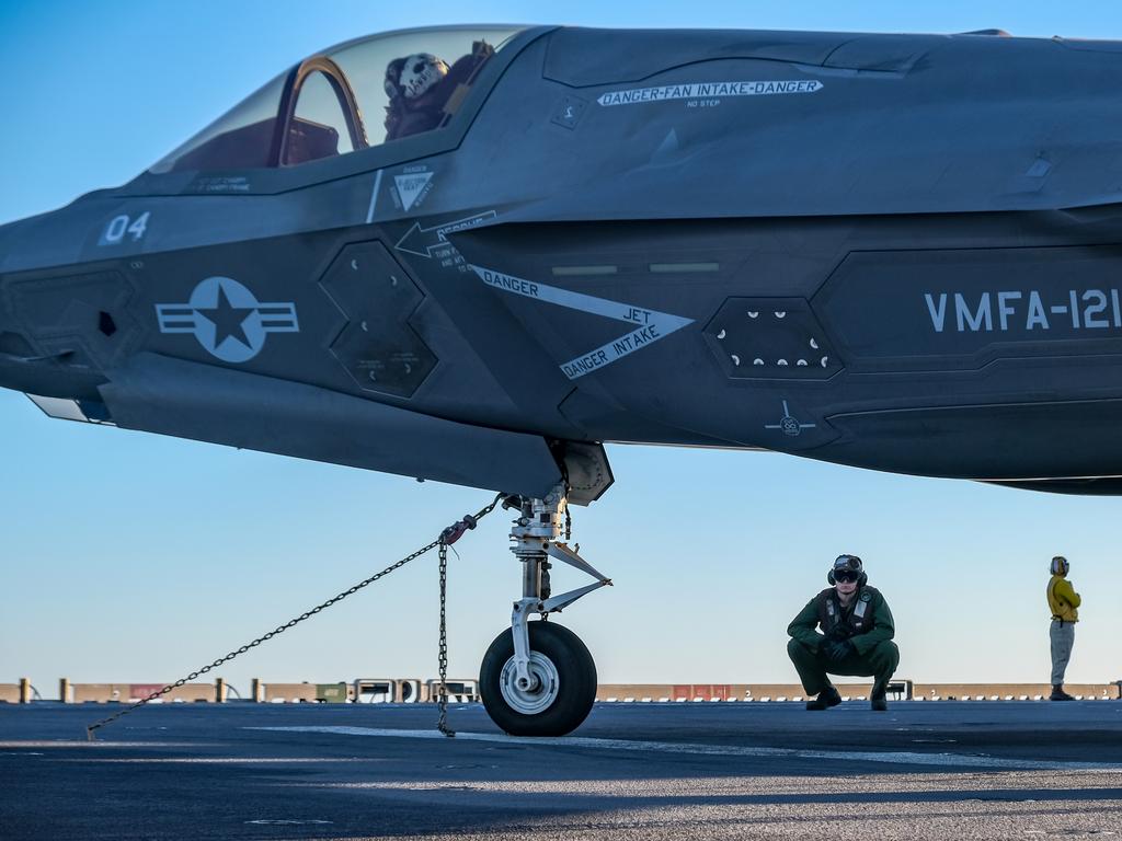 U.S. Marine Corps Lance Cpl. Steven Eckman monitors an F-35B Lightning II with Marine Fighter Attack Squadron 121 attached to Marine Medium Tiltrotor Squadron 265 (Reinforced), 31st Marine Expeditionary Unit (MEU), during Talisman Sabre on the flight deck aboard the amphibious assault ship USS America (LHA 6), July 20, 2021. The F-35B Lightning IIÃ¢â&#130;¬â&#132;¢s fifth generation strike fighter capabilities bring more lethality and flexibility to combat commanders than any other aircraft platform. Australian and U.S. forces combine biannually for Talisman Sabre, a month-long multi-domain exercise that strengthens allied and partner capabilities to respond to the full range of Indo-Pacific security concerns. The 31st MEU is operating aboard ships of America Expeditionary Strike Group in the 7th fleet area of operations to enhance interoperability with allies and partners and serve as a ready response force to defend peace and stability in the Indo-Pacific region. (U.S. Marine Corps photo by Staff Sgt. John Tetrault)