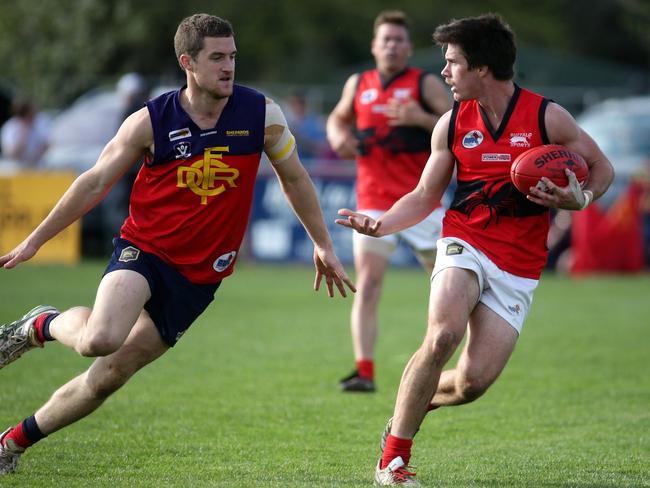 Matt Burkett of Romsey looks for a teammate during the RDFL footy grand final between Diggers Rest and Romsey played at Romsey on Sunday 20th September, 2015. Picture: Mark Dadswell