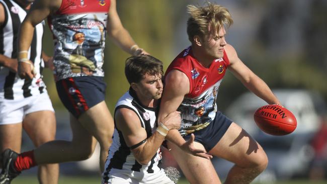 Reynella's Simon Karran tackles Flagstaff Hill's McKenzie Short during the sides’ battle on Saturday. Picture: AAP/Dean Martin