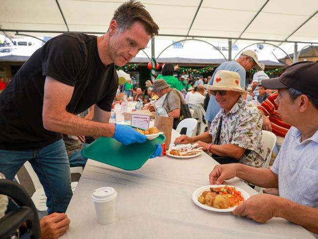 NSW Premier Chris Minns greets guests and serves meals at The Rev. Bill Crews Foundation’s annual Christmas lunch in Ashfield. Picture: Justin Lloyd