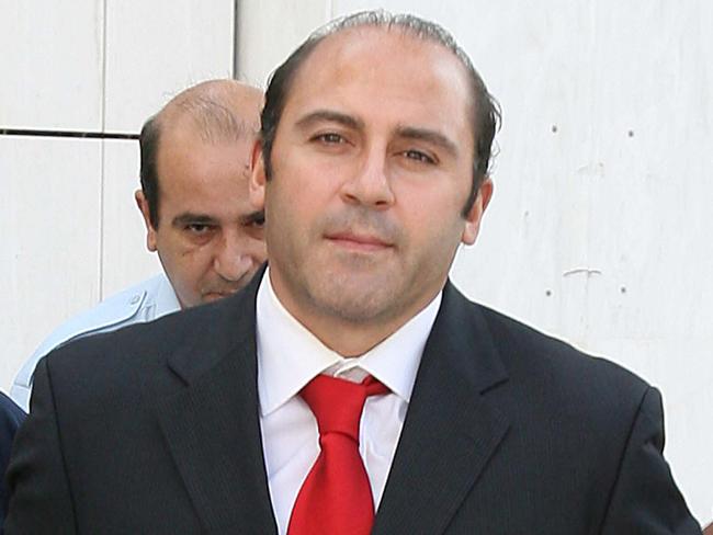 Victorian gangland member Tony Mokbel being escorted by Greek police officers outside court in Athens, Greece in 2007.