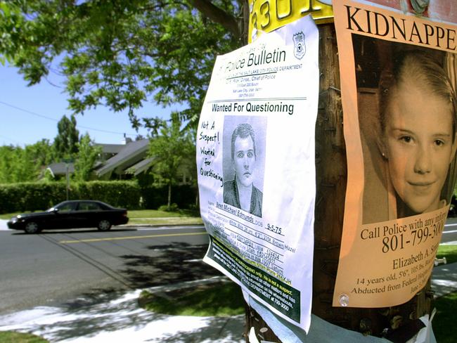 Posters of Elizabeth Smart and a man wanted for questioning hang side by side on a telephone pole in Salt Lake City, 13/06/02.