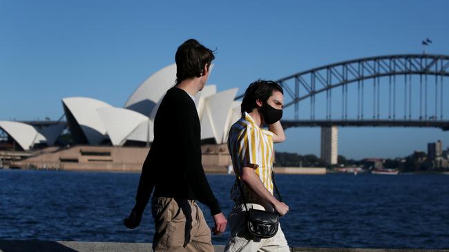 People are seen exercising along the Sydney Harbour shorefront this week. Picture by Lisa Maree Williams/Getty Images.