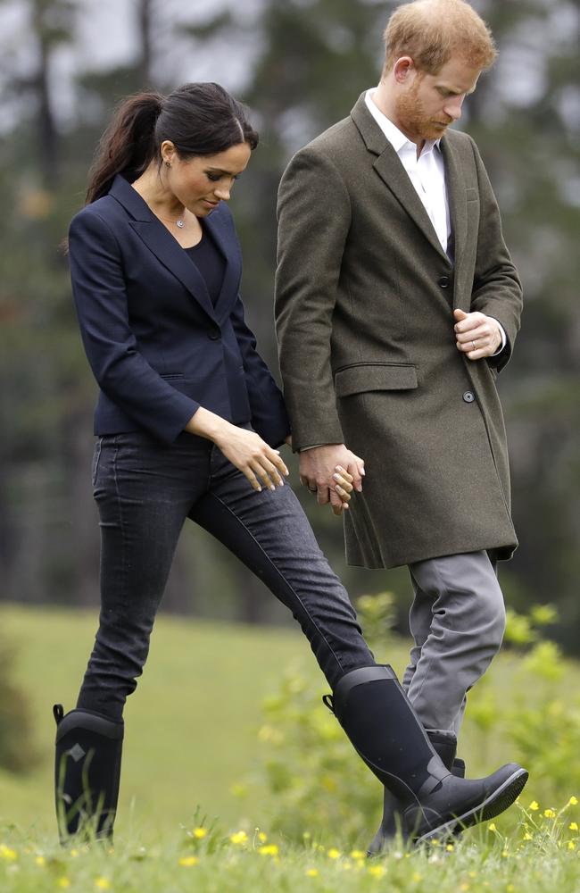 Britain's Prince Harry and Meghan, Duchess of Sussex take the weather in their stride. Picture: Kirsty Wigglesworth/AP