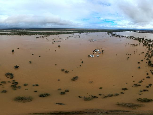 This handout photo taken on March 29, 2025 and released by The Queensland Fire Department shows homes under floodwaters in the town of Windorah in central-west Queensland. Whole herds of cattle have drowned in vast inland floods seeping across the Australian outback, officials said on April 1 as the muddy tide drenched an area the size of France. (Photo by Handout / QUEENSLAND FIRE DEPARTMENT / AFP) / RESTRICTED TO EDITORIAL USE - MANDATORY CREDIT 
