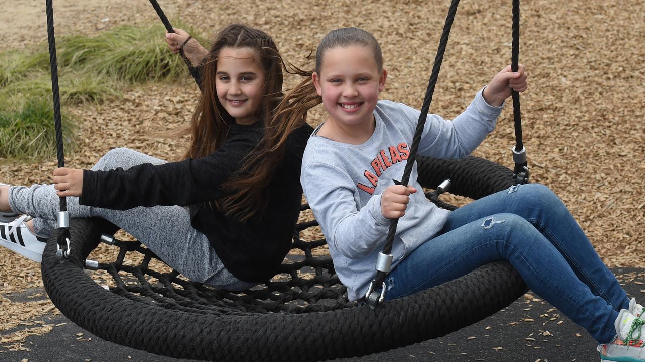 Charli Okun and Josslyn Appel enjoy the web swing at Mornington Park. Picture: Chris Eastman