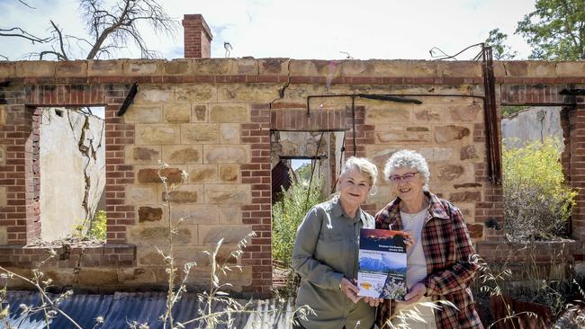 Sampson Flat Book.Denise Elland and Jan Verrall with their new book "Sampson Flat Bushfire, January 2015, A History: 100 Individual Accounts of Lessons Learned". Pictured at a burnt ruin.Wednesday 16 December 2020 Pic Roy VanDerVegt