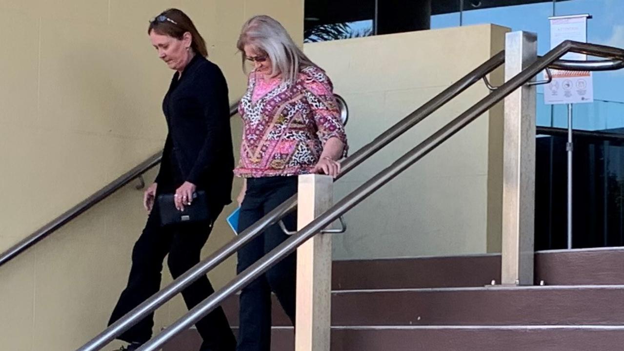 Narelle Ann Cooper (coloured top) leaves Mackay courthouse after day one of her the attempted arson trial in the district court.