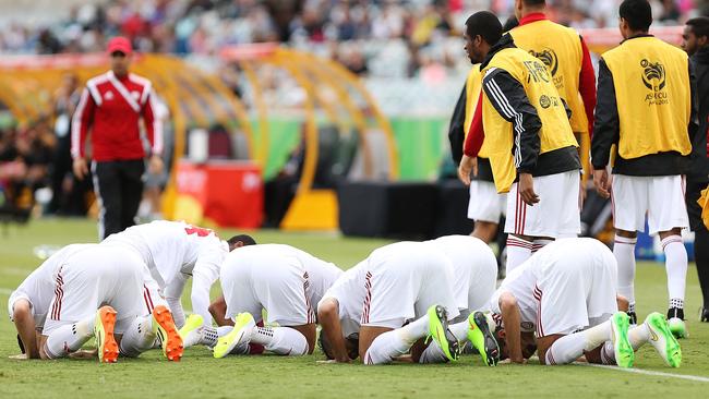 United Arab Emirates players celebrate after scoring against Qatar at Canberra Stadium.