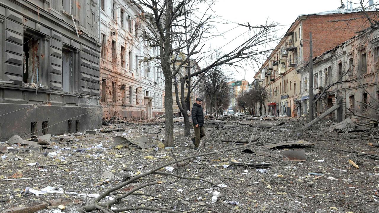 A pedestrian walks through debris in the street. Picture: Sergey Bobok/AFP