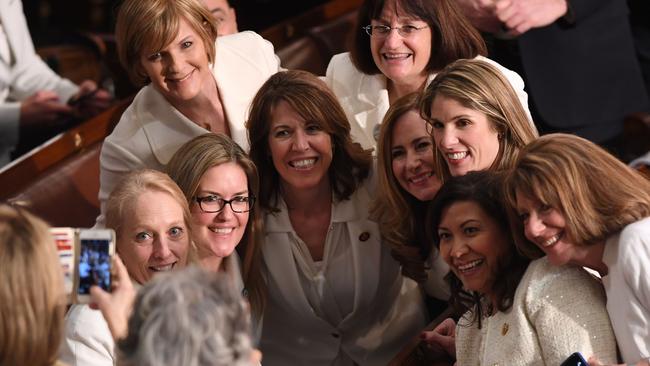 Congresswomen, dressed in white in tribute to the women's suffrage movement, pose for a photo as they arrive for the State of the Union address. Picture: AFP.